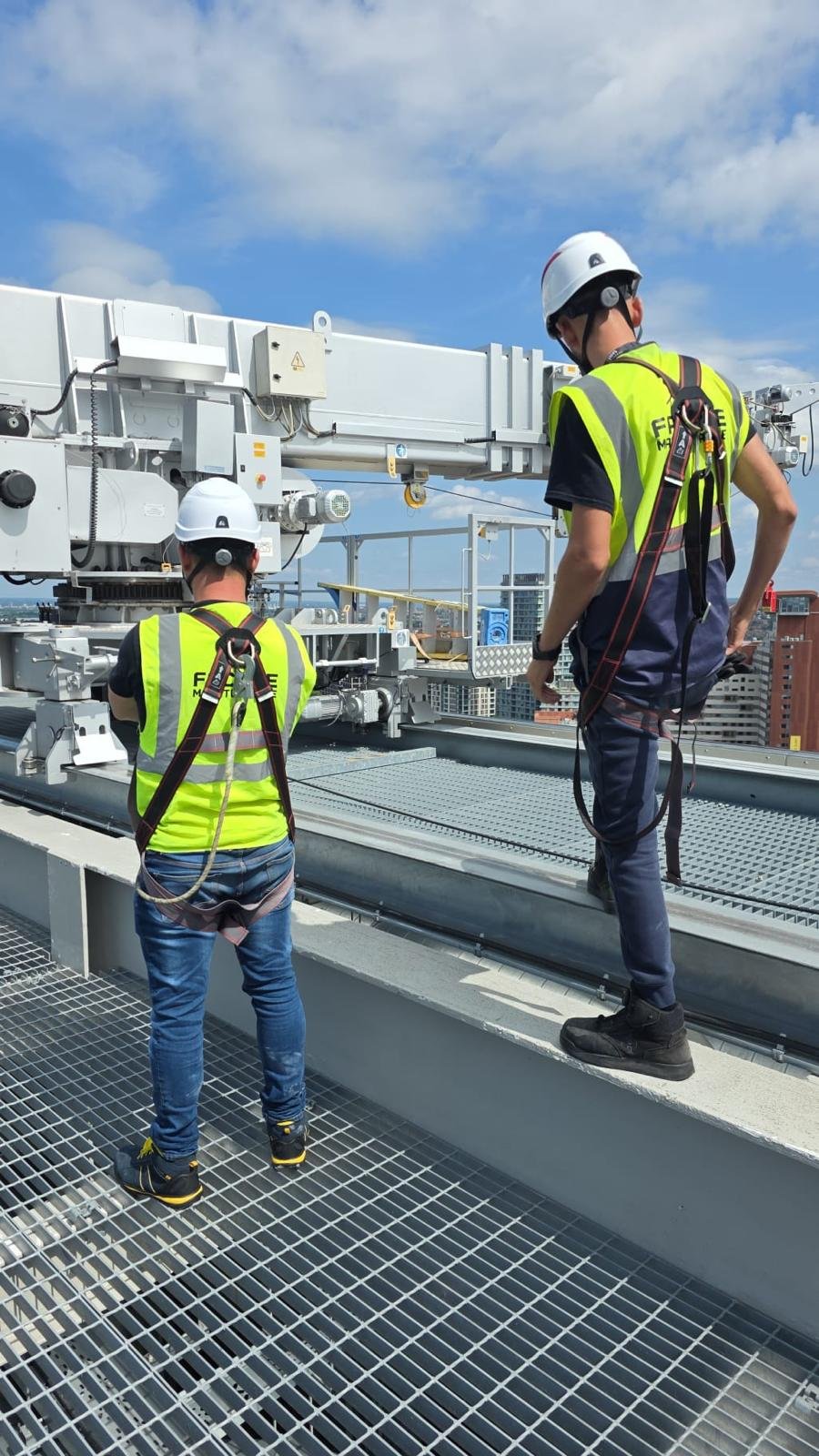 Crew operating a building maintenance unit on a rooftop