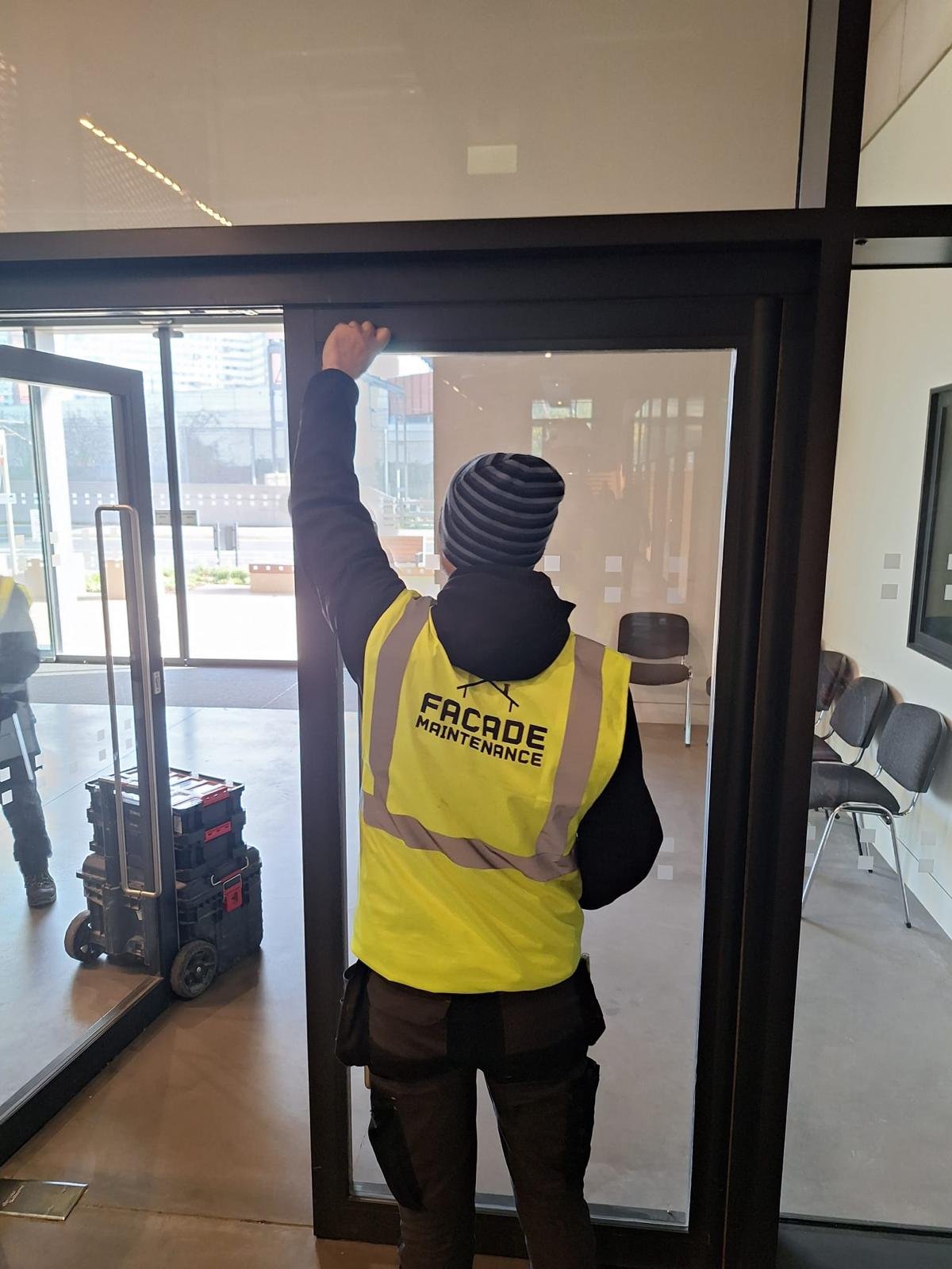 Technician installing an internal glazed screen and door